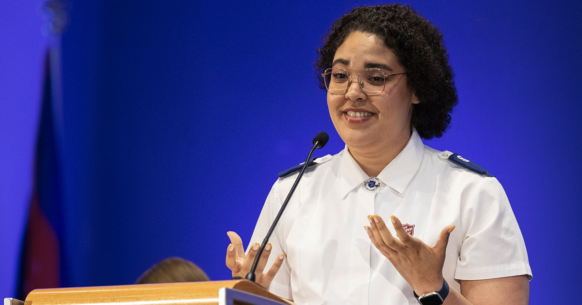 A young woman speaks at a lectern