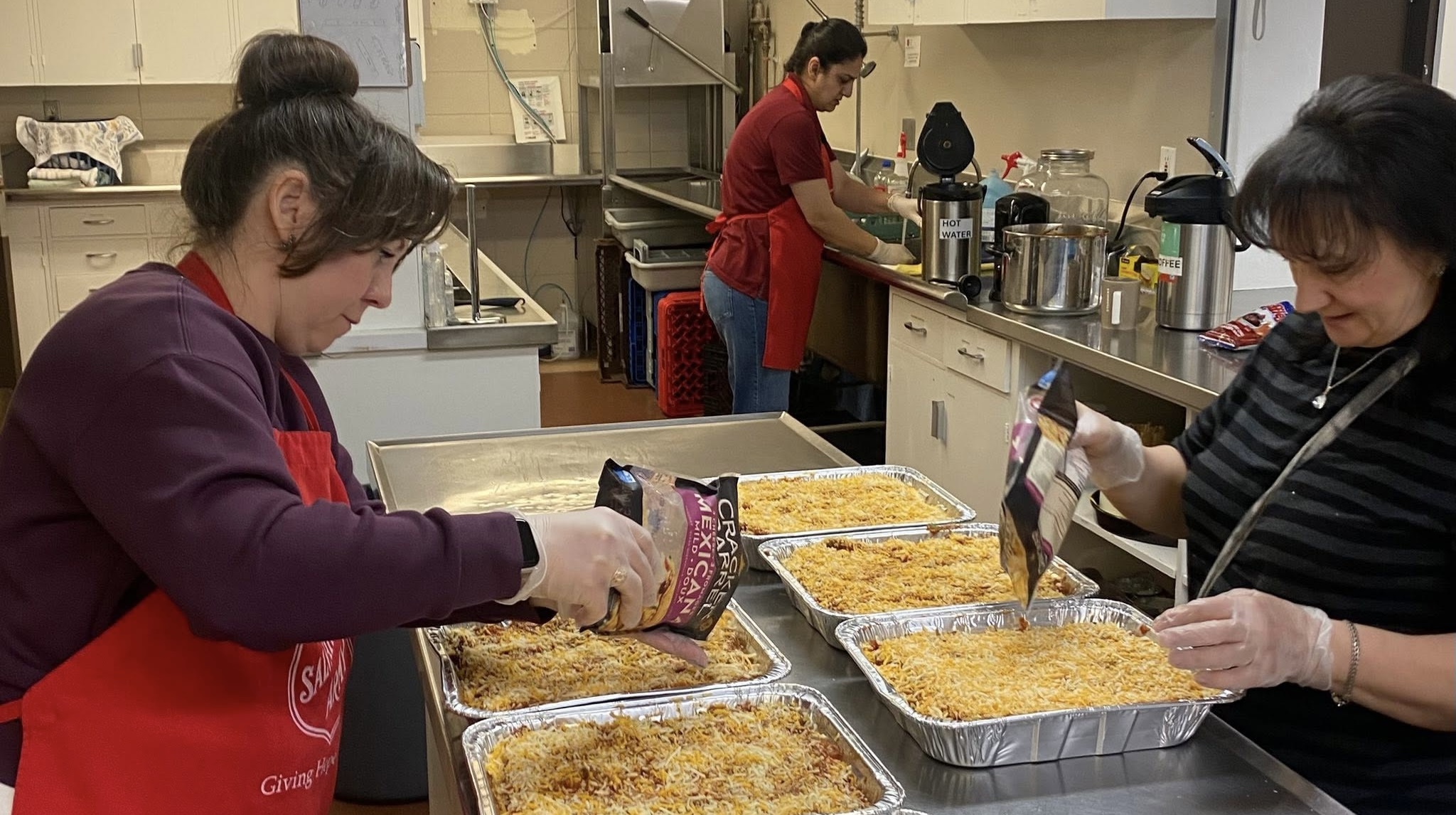 Salvation Army workers prepare meal for vulnerable people